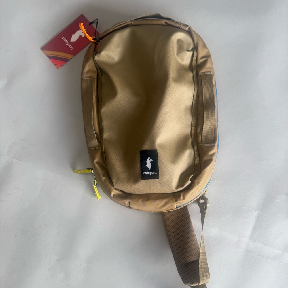 Cotopaxi Tan Backpack with Blue and Yellow Accents